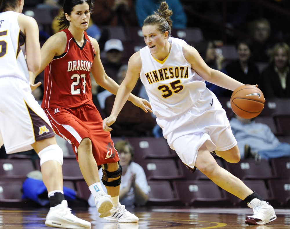 Junior guard Katie Ohm dribbles around an opponent in one of Minnesotas two exhibition games at Williams Arena this year. The Gophers will head to the West Coast for a pair of games this weekend including its season opener against No. 2 Stanford. 