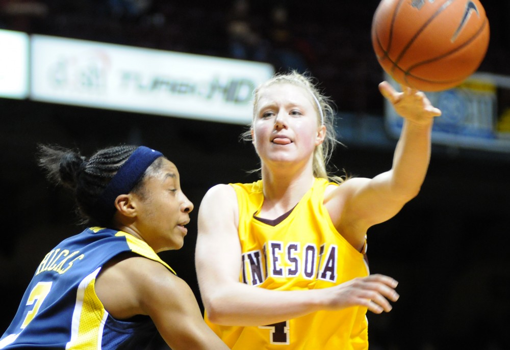Senior guard Emily Fox looks for an outlet as she faces some tough pressure against Michigan during Sunday’s 52-46 comeback win over the Wolverines at Williams Arena. 
