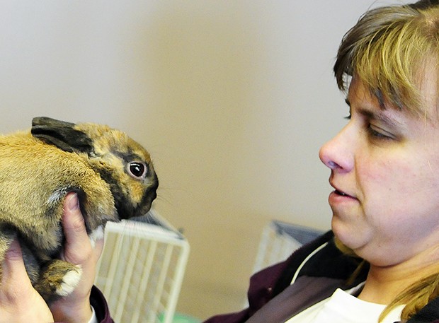 South Fargo resident Debbie Faber says goodbye to Peanut, her rabbit, at the Red River Zoo in west Fargo on Saturday. The Faber family brought their two rabbits to the zoo and their cat to the fairgrounds on Friday after they evacuated their home.