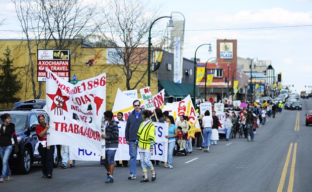 A group of protestors march down Lake Street on Friday during a demonstration. The march was organized by the Minnesota Immigrant Rights Action Coalition and had over 300 people in attendance.