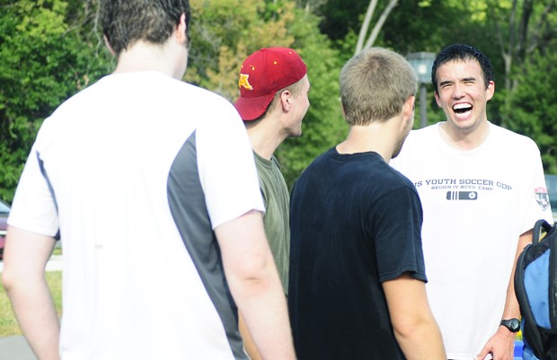 University junior Bradford Paik, far right, laughs with other FIRE group members at the East River Flats on Friday. 