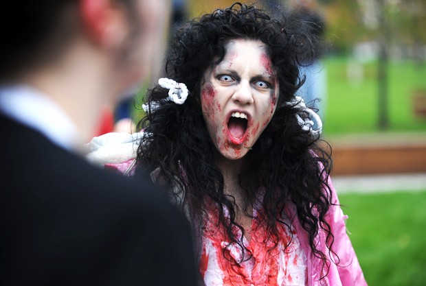 Felicia Mitchell of Bloomington gets into character during the fifth annual Minneapolis Zombie Pub Crawl on Saturday at Gold Medal Park.