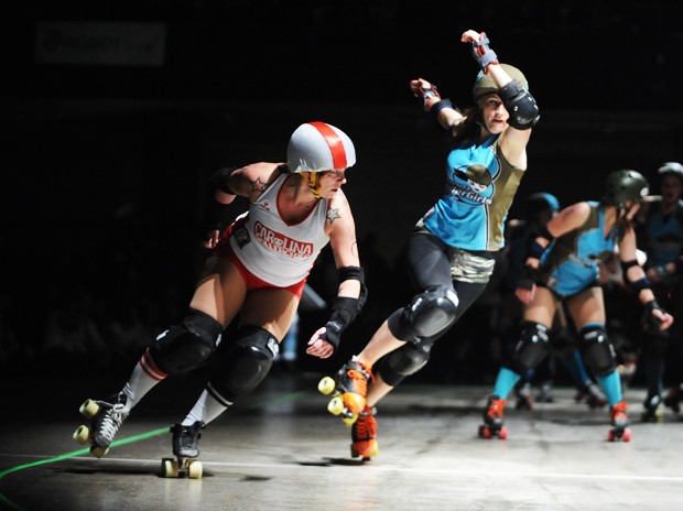 Alex Lacey, right, and her Minnesota RollerGirl All Star League teammates compete against the Carolina Rollergirls at Roy Wilkins Auditorium on Saturday. The team of all-female roller derby players kicked off their sixth season with a win.