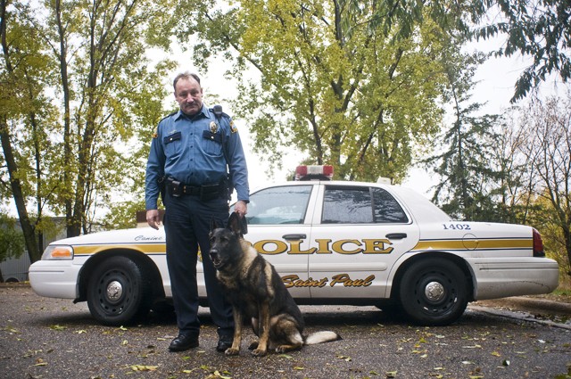 St. Paul K-9 Officer Peter Renteria stands next to his dog Lance at the St. Paul Police Canine Unit Timothy J. Jones Training Facility on Wednesday. Lance is being treated for cancer at the University.