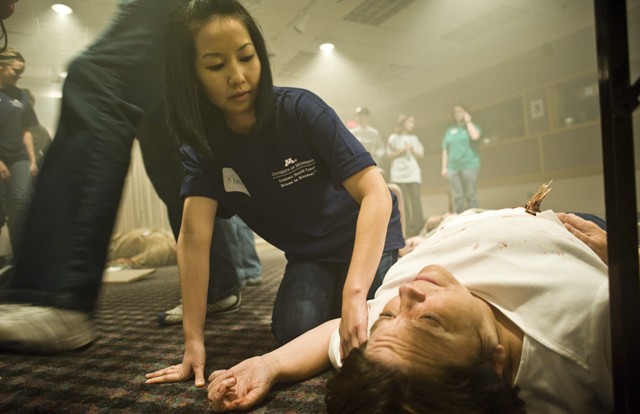 University Pharmacy student Khanh Phan checks the pulse of South Minneapolis resident Peg Pederson during a simulation at Disaster 101 in the Earle Brown Continuing Education and Conference Center in St. Paul on Friday. 