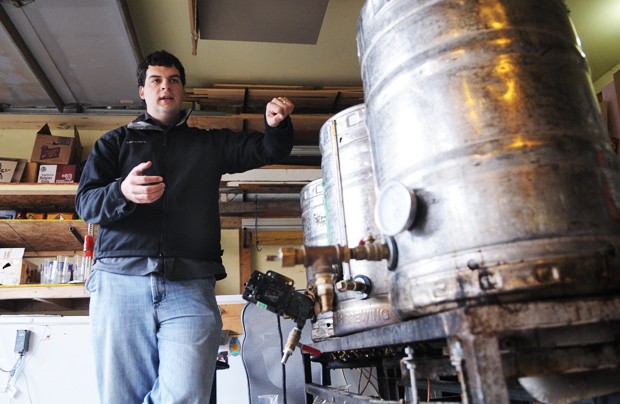 Ryan Petz, a graduate student at the Carlson School of Management, explains the brewing process Monday in his co-worker’s garage in Minneapolis. Petz is the co-founder of Fulton Beer and has brews on tap at numerous area bar and restaurants.