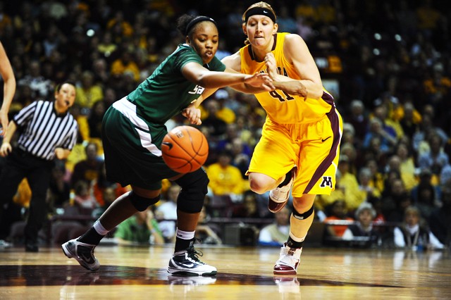 Michigan State sophomore guard Porsche Poole fights for the ball against Gophers sophomore forward Brianna Mastey during the first half of the Gopher’s 57-66 loss. 