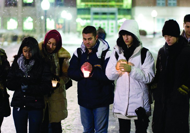 Students gather for a candle-lit vigil in front of Coffman Memorial Union on Monday. The demonstration was part of Gaza Week put on by Break the Bonds.