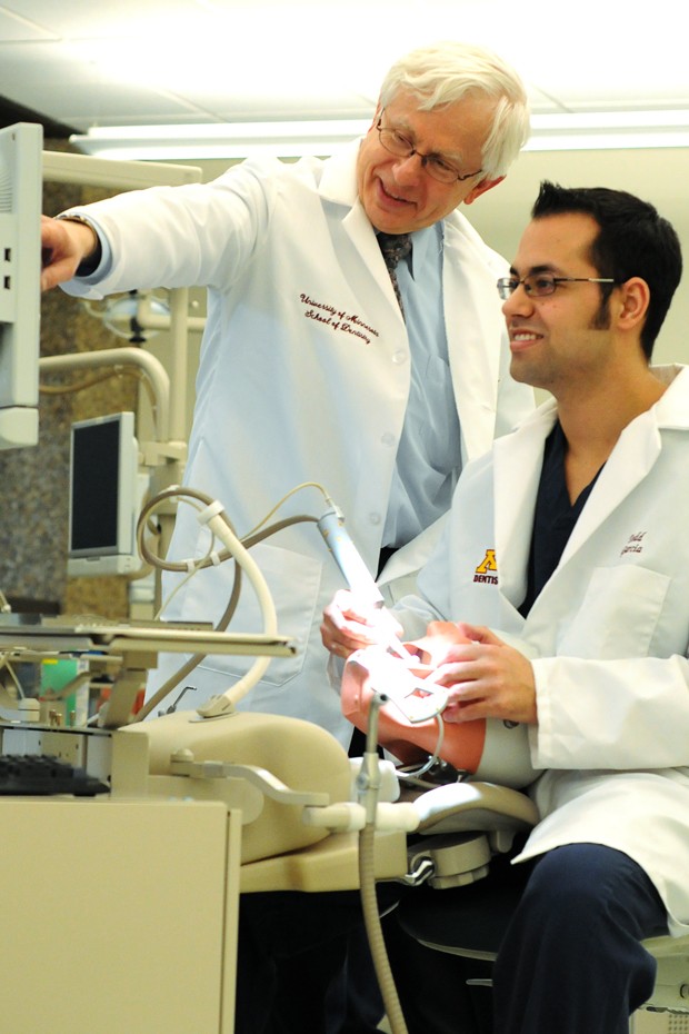 Professor Peter Berthold helps a second-year student fill a cavity in the advanced simulation clinic Monday. The two-year-old simulation lab is one of several ways dental students and faculty benefit from advancements in technology.