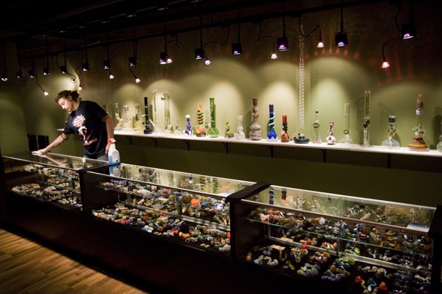 Aaron Becquer, a Junior Marketing Psychology Major at Augsberg  
University, cleans a counter at Sherlox Parlour last Monday. Sherlox  
Parlour is a new head shop in Dinkytown that features hand blown glass pipes from local artists.
