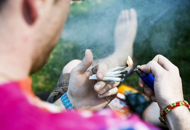 A University student lights four marijuana joints in celebration of 4/20 in the Mall Area on Tuesday. 