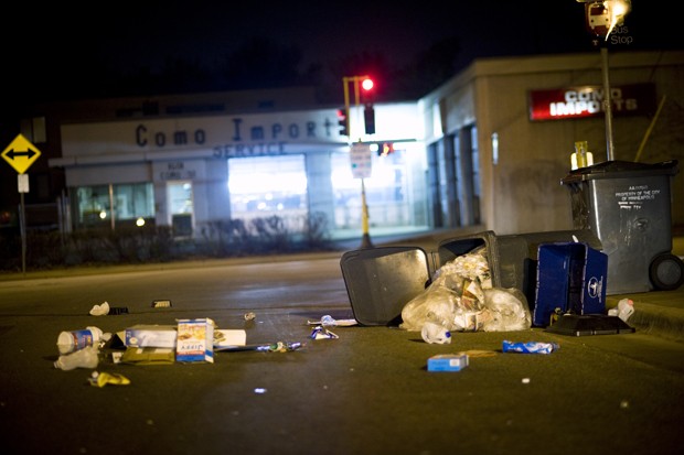 Trash is scattered on the street after a trash can was knocked over on the corner of 15th and Como ave.