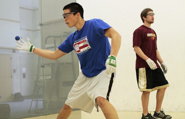 First year University student Nico Balcos and junior Nick Olson play handball at the Recreation Center.