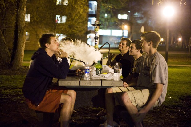 Freshman students try out their new hookah on their dorm lawn. 