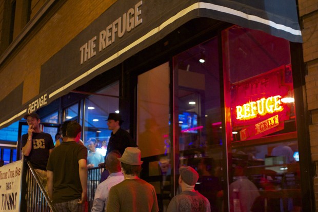 Patrons wait outside The Refuge on Sunday night in Downtown Minneapolis