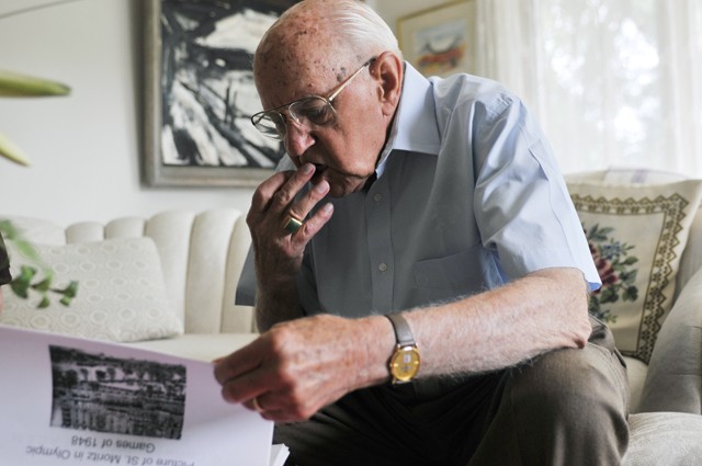 Doctor V. George Nagobads looks through a packet describing an eastern European game called bandy, a sport similar to hockey, at his house in Edina on Tuesday morning.  Nagobads will be enshrined into the Gopher Hockey Hall of Fame on September 9 and inducted into the National Hockey Hall of Fame on October 21.
