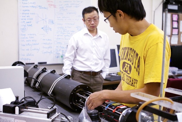 Assistant professor of aerospace engineering Jian Sheng and aerospace engineering senior Yan Ming Tan assemble their high seed underwater 3D camera Saturday in Akerman Hall.  The camera is able to capture the interactions of algae with particles of oil, which could help scientists better understand impacts of the spill in the Gulf on the ocean’s carbon cycle.
