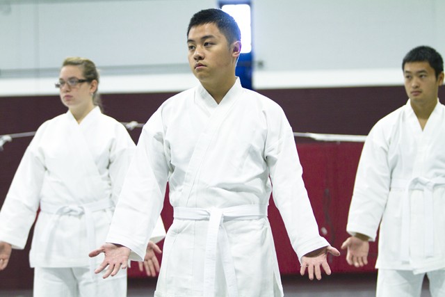Freshman Keen Thao practices karate with his class Monday morning in Cooke Hall.