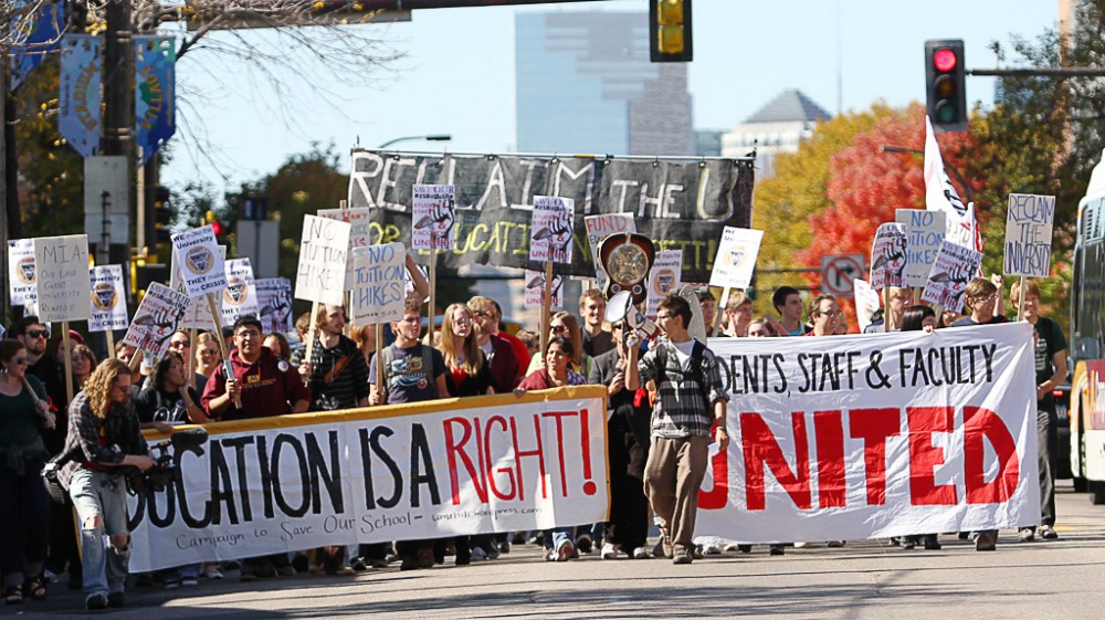 Protesters march down Washington Avenue following a Chop from the Top rally in Northrop Mall on Thursday. 