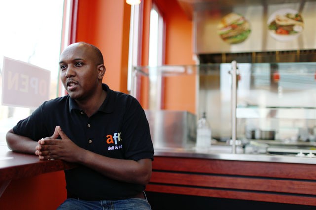 Abdirahan Kahine, owner of Afro Deli & Coffee talks about the grand opening of his deli in the West Bank area on Friday
