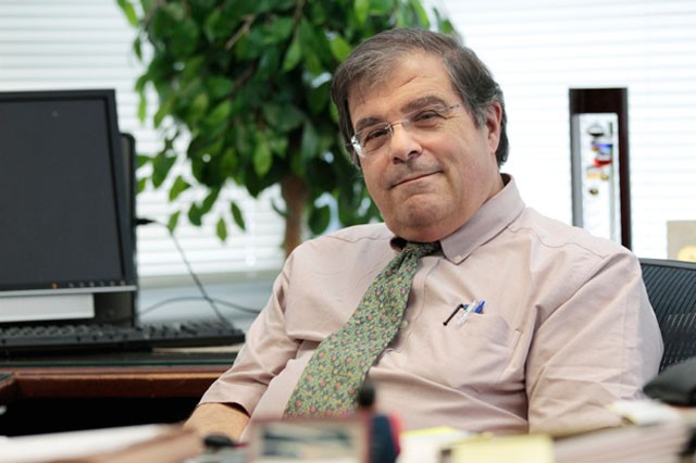 Academic Health Center Vice President and Medical School Dean Frank Cerra takes a break on Friday in his office at the Child Rehab Center.
