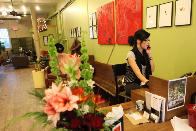 Receptionist Allie Walsh schedules an appointment Tuesday evening at Rue 48 Salon in Minneapolis. The Salon merges their services with local art displayed on their walls and performance events scheduled periodically. 
