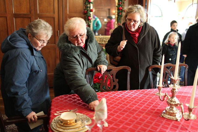 Katherine Langdon, left, Mary Ellison, center, and Wendy Hain, right look at displays at the governors mansion on Tuesday in St. Paul.
