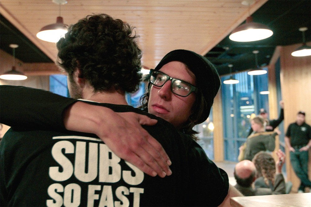 Davis Ritsema hugs David Boehnke after hearing the results of a vote held Friday in Block E in downtown Minneapolis. Employees from 10 Jimmy John’s franchises voted 87 to 85 against unionizing their workforce.