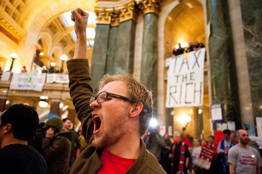 Jabob Moe chants protest slogans as Capitol Police threaten to arrest demonstrators remaining in the rotunda on the night of Feb. 27.  Moe, 21, dropped out of classes at Madison Area Technical College to take part in the protests against Gov. Scott Walkers budget repair bill.