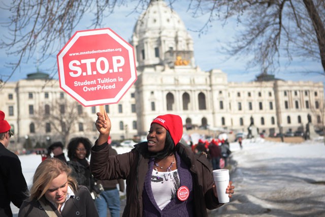 Ophelia Mensah from Saint Paul College gets fellow students fired up Wednesday morning during the march to the State Capitol. 