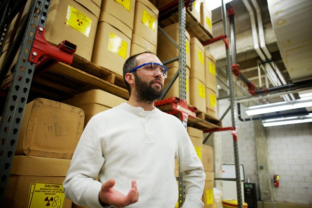 David Paulu describes the contents of hundreds of boxes containing radioactive waste Friday at the Thompson Center.  The waste comes from thousands of labs across the University that use radioactive material in research, such as for chemotherapy.