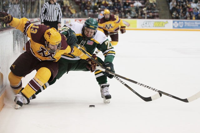 Gophers junior forward Nico Sacchetti and Anchorage sophomore defender Drew Darwitz fight for the puck on Friday March 11 at Mariucci Arena.
