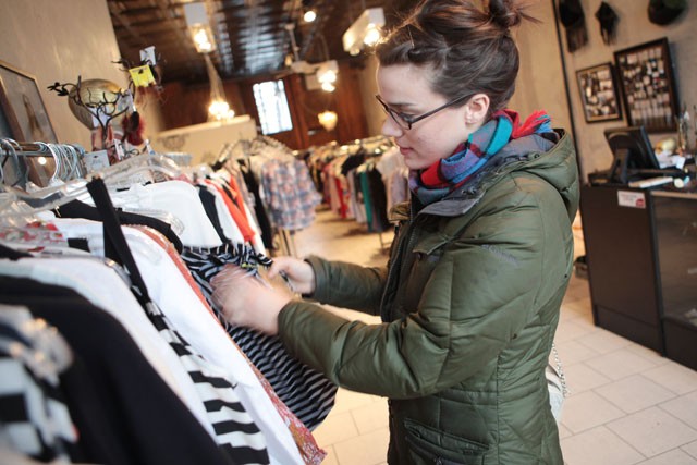Jessica Norling searches for new clothing Monday afternoon at the store Cliché in Uptown. Norling lives close by and shops there for their plethora of unique clothing options. 