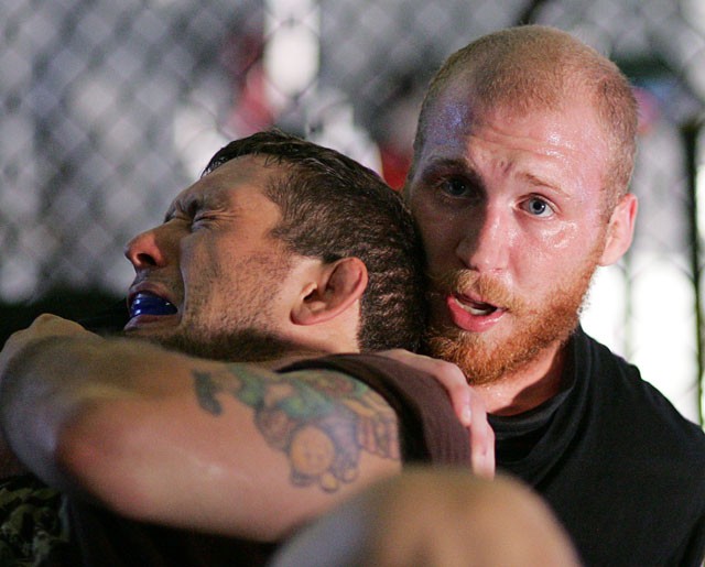 Nick Thompson, right, demonstrates a hold on training partner Derrick Noble during training Tuesday, July 22, 2008, in Brooklyn Park, Minn., in preparation for an EliteXC  welterweight championship fight Saturday, three days before talking the Minnesota Bar Exam. (AP Photo/Andy King)