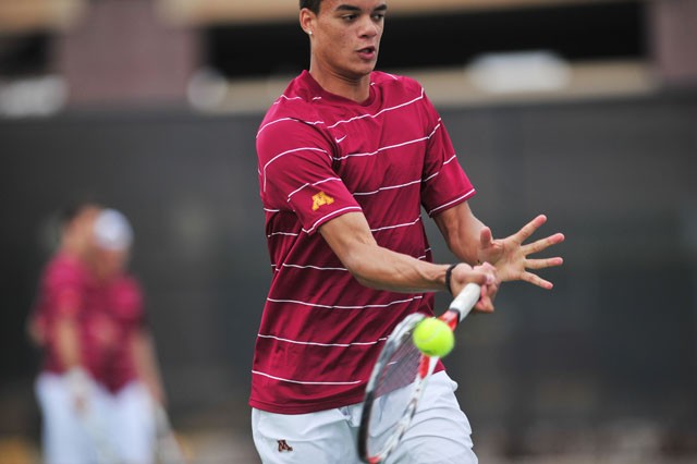 Sophomore Brendan Ruddock volleys the tennis ball at the Baseline Tennis Center against Purdue on Sunday. 
