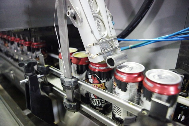 The aluminum lids are shot with a small burst of CO2 to prevent oxygen in the can once the cans are sealed. 
