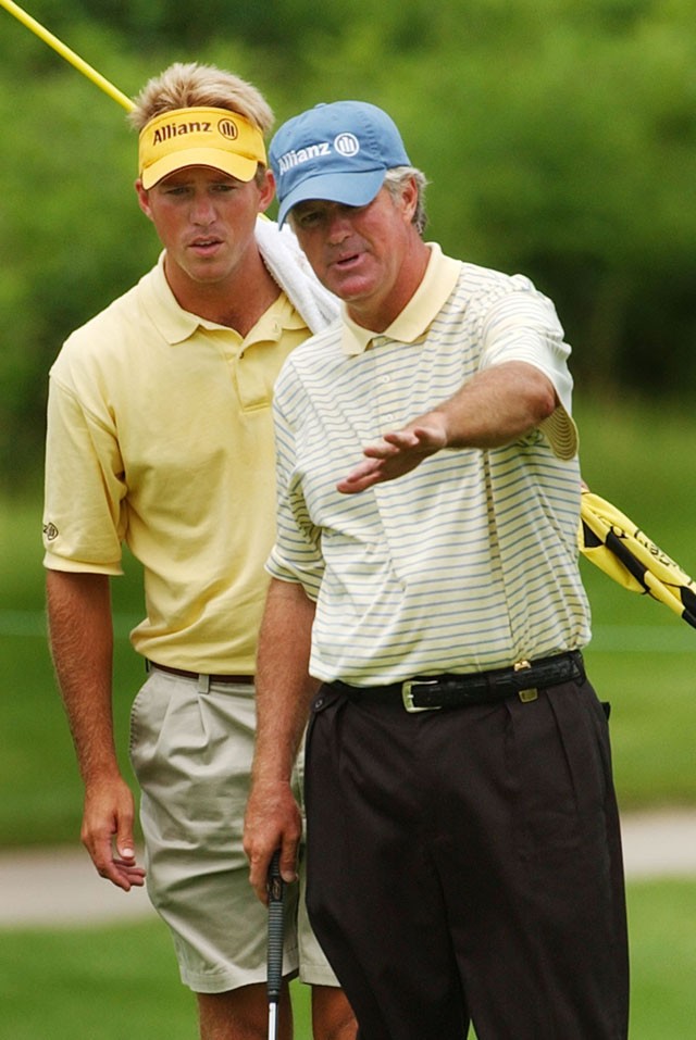 John Harris, right, and caddie Ernie Rose line up a putt on the 18th green of The National Golf Club during the first round of the Bayer Advantage Celebrity Pro-Am in Parkville, Mo., Friday, June 11, 2004. (AP Photo/Orlin Wagner)