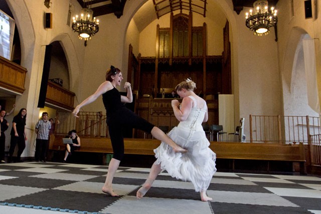 Kathryn Jacobs kicks Rachel Piersdorf Thursday during Human Combat Chess at the University Baptist Church in Dinkytown.  Six Elements Theatre Company is putting on the production, which features mock battles and sword fighting,