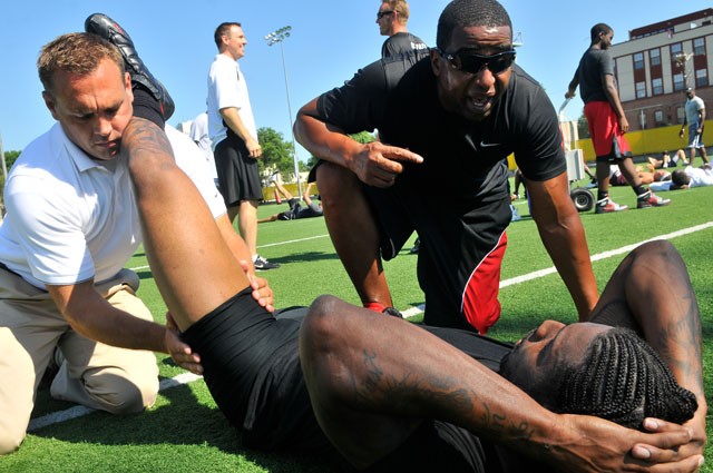 Former NFL player Cris Carter talks to Kansas City Cheifs wide receiver Dwayne Bowe during a training camp on July 8, 2010 at Bierman Field.