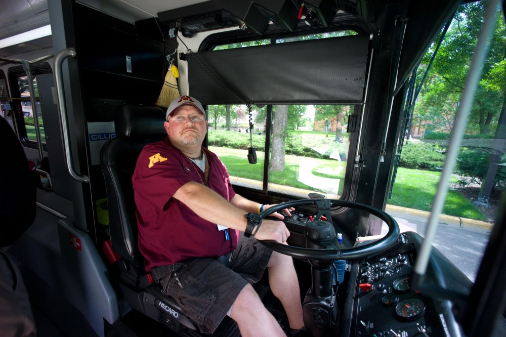 Campus Connector driver Joe Filey looks in the rear-view mirror to ensure the rear door is cleared. This fall will mark Fileys fourth year driving on campus.