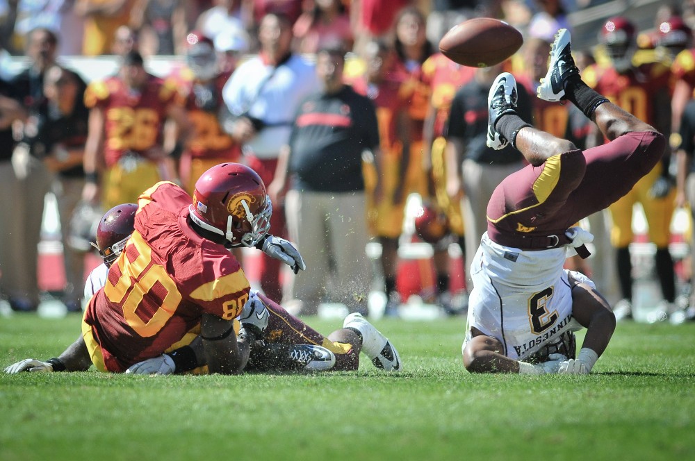 Gophers senior defensive back Kim Royston does somersaults after missing a tackel.