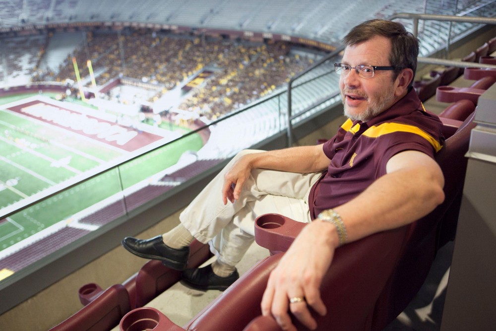 President Eric Kaler sits in his suite watching the freshman pep rally on Friday night at TCF Bank Stadium.