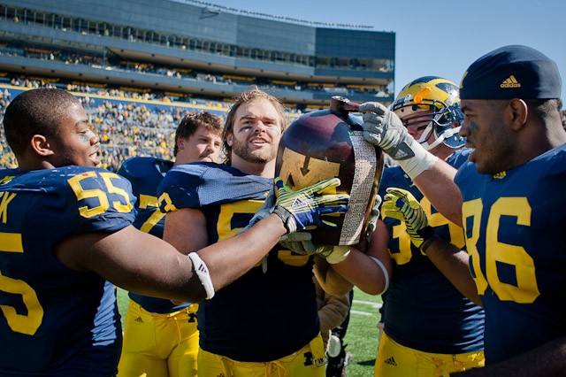 Michigan carries the Little Brown Jug after crushing Minnesota 58-0 Saterday at Ann Arbor, Mich.