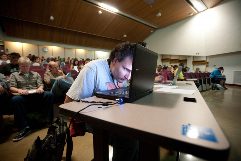 Psychology major Luka Krmpotich peers at the notes on his laptop during his statistics class last week in Anderson Hall. Krmpotich is blind in one eye and has 20/200 vision in the other.