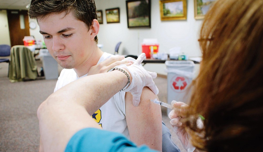 Tyler Jay Carey gets a flu vaccination during a clinic Wednesday at Boyton Health Service.  A University of Minnesota study published Tuesday found that the seasonal flu vaccine has a efficacy rate of only 59 percent.