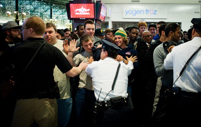 Shoppers attempt to push through security staff just after midnight Friday outside of Best Buy at the Mall of America.