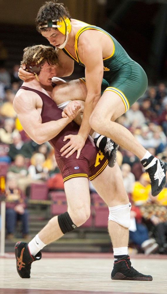 Minnesotas Kevin Steinhaus (184) lifts North Dakota States Mac Stoll during their match Sunday at the Sports Pavilion.