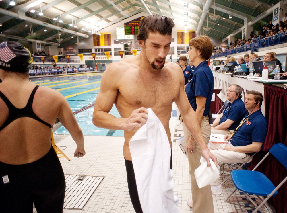 Michael Phelps walks to the locker room after completing the championship final of the Mens 200m Individual Medley event at Minneapolis Grand Prix on Sunday at University Aquatic Center.