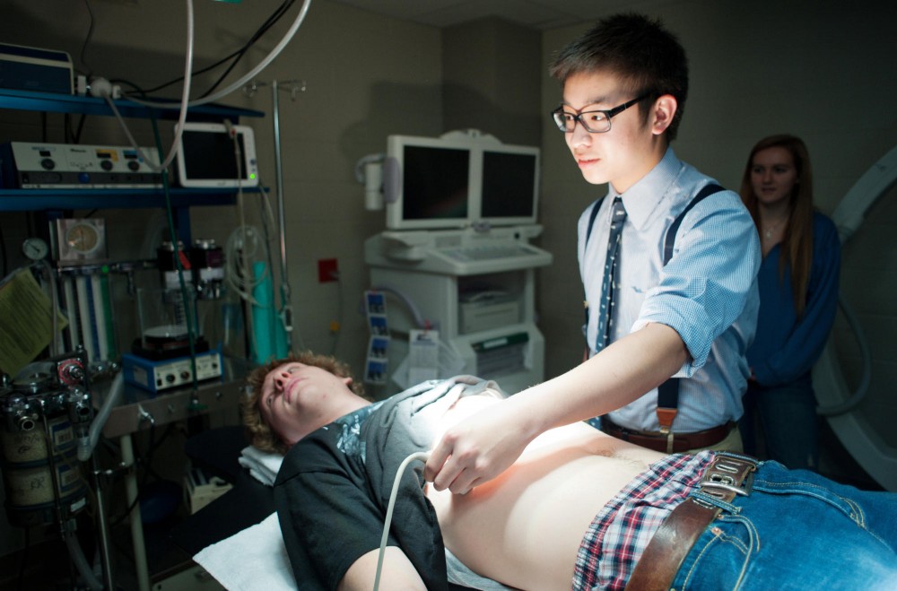 Blaine High School students Nick XXXX, left, and Jonathan XXXX, right, practice using an echo machine Thursday at the Experimental Services lab.