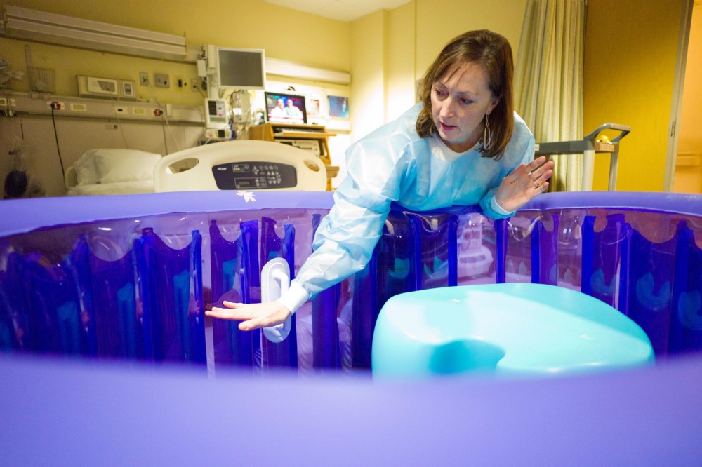Ann Forster Page, certified nurse-midwife, displays a water birthing tub  Wednesday at Fairview Clinics - Riverside. The hospital began to offer the more natural birthing method in Oct.  